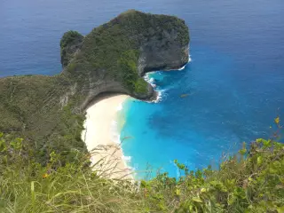 Illustration: A high cliff overlooks a secluded white sand beach and turquoise ocean.