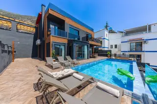 Illustration: Sun loungers lined up beside a private swimming pool outside a modern holiday villa.
